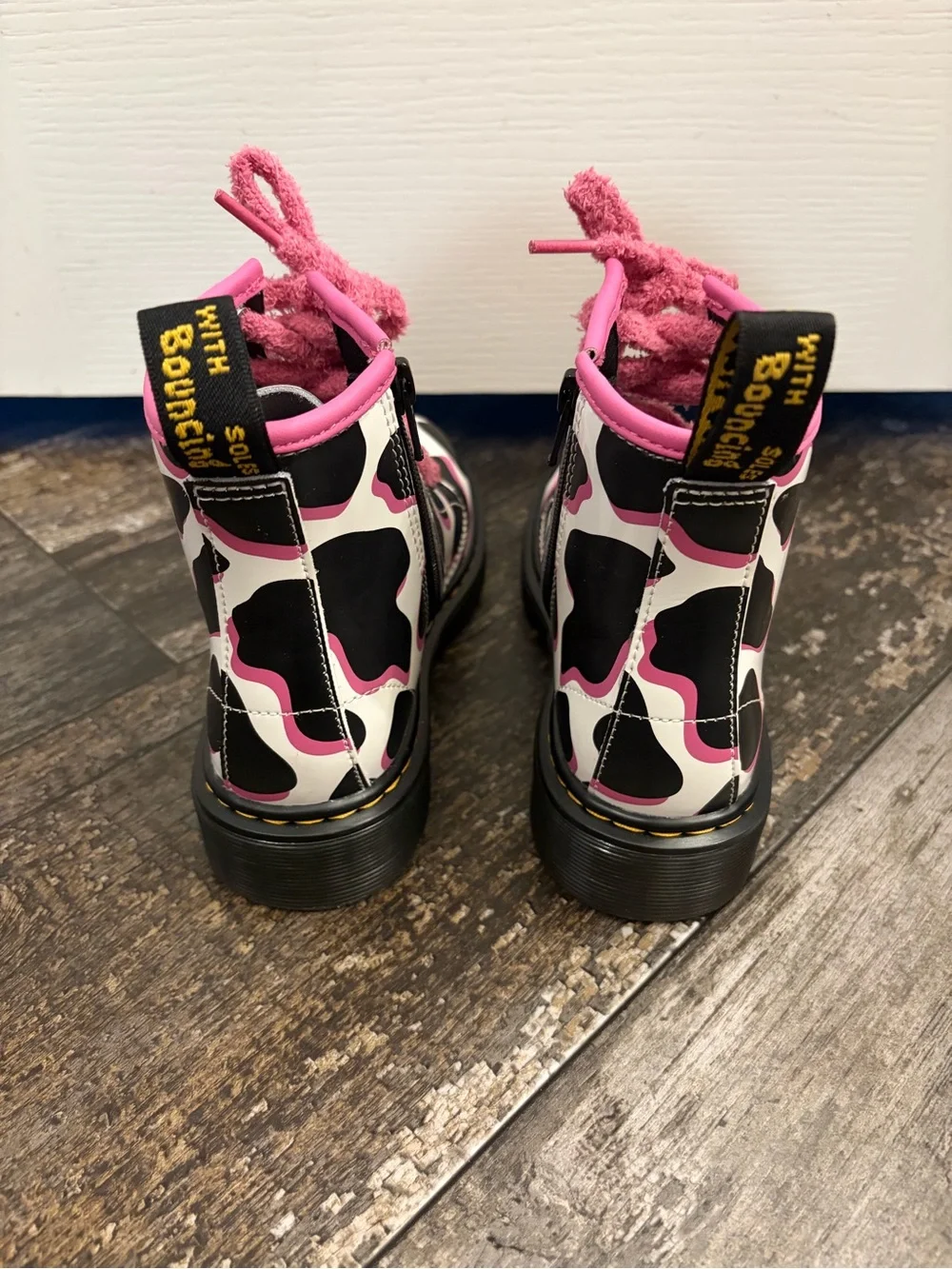 Dr Martin’s Black & White Cow Print Combat Boots with Pink Trim and Laces